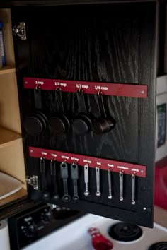 the measuring cup organizer is organized and ready to be used as a tool holder for kitchen utensils