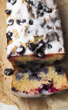 two slices of blueberry bread are on wax paper