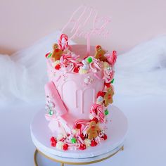 a pink birthday cake decorated with candy and candies