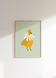 a yellow duck with white wings on a green and white checkered background in a room