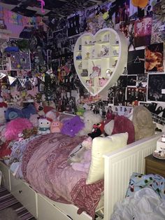 a bed with lots of stuffed animals on it in a room filled with pictures and photos