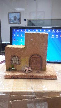 a small house made out of clay sitting on top of a table