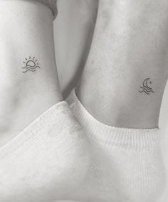 two small sun and moon tattoos on the wrist