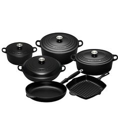 an assortment of black pots and pans on a white background with the lid open