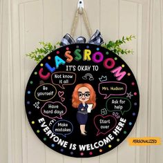 a black circular sign that says classroom it's okay to everyone is welcome