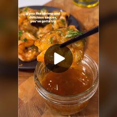 a glass jar filled with food on top of a wooden table