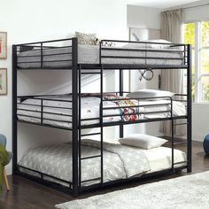 a bunk bed with two sets of mattresses on the bottom and one set below