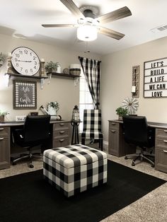 a living room filled with furniture and a large clock mounted to the wall above it