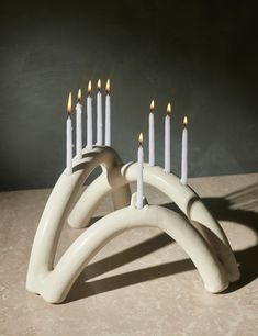 a group of white candles sitting on top of a table