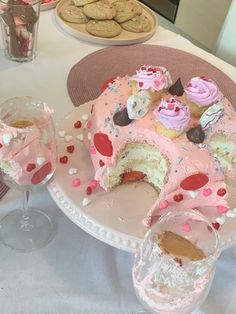 a cake with pink frosting and sprinkles on it