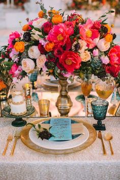 a table with flowers and candles on it