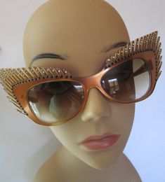 "Stunning Mardi Gras style vintage fantasy eyewear sunglasses. Handcrafted beauties like this are rare and highly collectible, one of a kind, hand painted. Coppery brown frames, carved eyelashes and smoked plastic lens. Art Deco feathers fan out into winged cat eye. Sparklies and clear faceted rhinestones dot eyelashes. Mikli Paris Hand Made in France #029633/ Lens measures 2-1/2\"/6.5cm x 1-1/2\"/4cm , temple 5-1/4\"/13.5cm, total width of glasses 9-1/4\"/23-1/2cm, total height 3\"/7-1/2cm. Con Vintage Glass Sunglasses For Parties, Vintage Glass Sunglasses For Party, Vintage Glass Sunglasses For Evening, Gold Cat Eye Sunglasses For Party, Luxury Gold Cat Eye Sunglasses For Party, Gold Glass Cat Eye Sunglasses For Party, Vintage Party Sunglasses With Glass Lenses, Gold Cat Eye Party Sunglasses With Glass Lenses, Vintage Sunglasses With Tinted Lenses For Party