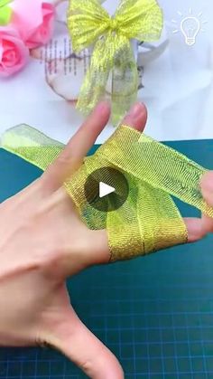 a person is making something with yellow ribbon