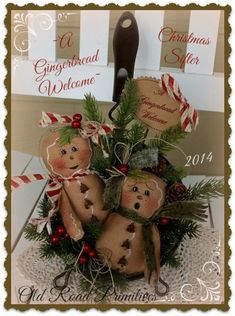 a christmas card with three gingerbreads in the center and candy canes on top