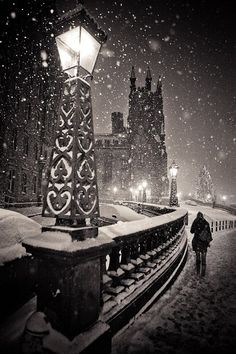 a person walking down a street in the snow