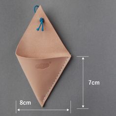 an origami envelope with blue string attached to it