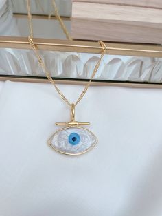 Nazar necklace, evil eye, Evim Eye 14k gold plated The chain shown is 45 cm long. This beautiful necklace is an eye-catcher for special appearances for special people. Also perfect as a gift for your loved one on Valentine's Day. Chain length 45 cm Pendant and chain 14k gold plated Please avoid situations where your jewelry comes into contact with soaps, lotions, hairspray or other chemicals as these can discolor and damage your jewelry. All of the necklaces' clasps are super easy to open so you Spiritual Gold Eye-shaped Necklace, Gold-plated Evil Eye Amulet Necklace, Gold Plated Evil Eye Amulet Necklace, Blue Gold-plated Chain Necklace As Gift, Blue Gold Plated Chain Necklace As Gift, Gold Evil Eye Pendant Charm Necklace, Blue Necklace With Diamond Eyes As Gift, Gold Chain Necklace With Evil Eye As Gift, Gold Chain Necklace With Evil Eye For Gift