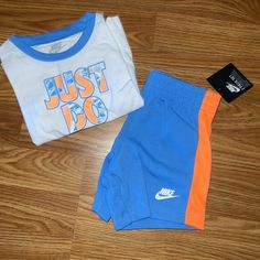 Nwt Nike Outfit 12 Months Short Sleeve Top And Bottoms Nike Blue Cotton Sets, Blue Sporty Playwear Set, Nike Blue Playtime Sets, Casual Orange Playtime Sets, Sporty Blue Sets For Playtime, Casual Orange Playwear Sets, Playful Blue Nike Tops, Black Nike Tracksuit, Nike Jogging Suits