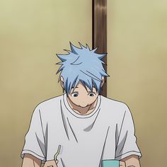 a man with blue hair sitting at a table in front of a cup and saucer