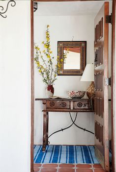 an entry way with a table and mirror