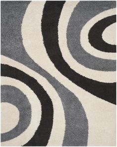 a brown and white area rug with swirls on the bottom, in various colors