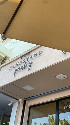 an umbrella is hanging over the entrance to a restaurant