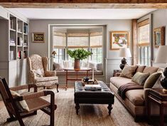 a living room filled with furniture and lots of windows