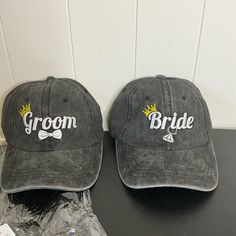 two gray hats with the word groom and bride on them sitting next to each other