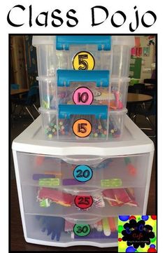 an organized classroom desk with plastic drawers and numbers on the bottom shelf, labeled class dojo