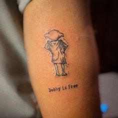 a person with a tattoo on their arm that says dobby is free