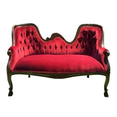 an old fashioned red velvet couch