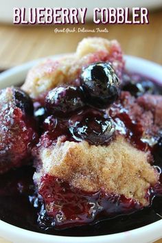 blueberry cobbler in a white bowl on a wooden table with text overlay