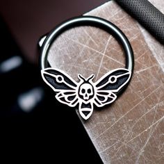 IMPORTANT (size & measuring guide): https://metallotus.com/blogs/body-jewelry/how-to-measure-your-piercingHandmade one at a time out of niobium and tarnish-resistant sterling silver - completely nickel free. This 16 gauge death moth captive bead ring works well for septum, daith, conch and helix piercings.The hoop is made out of pure, unalloyed niobium, and the captive bead is made out of Argentium silver that has been carefully antiqued then given a hand-brushed finish to highlight the blac Cool Septum Jewelry, Moth Ring, Cute Septum Rings, Daith Piercings, Captive Bead Ring, Conch Piercings, Septum Piercing Jewelry, Helix Piercings, Septum Rings