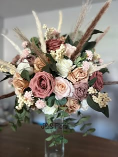 a vase filled with flowers on top of a wooden table