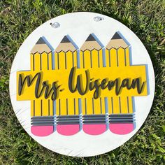 a sign that reads, mr and mrs wisconsin with pencils on it in the grass