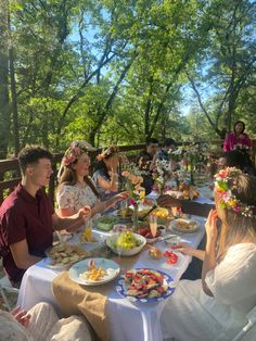 a group of people sitting around a table eating food