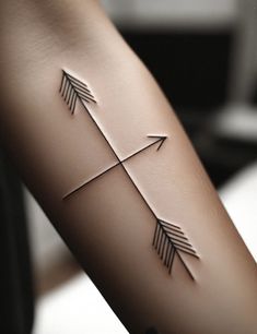 an arrow tattoo is shown on the arm