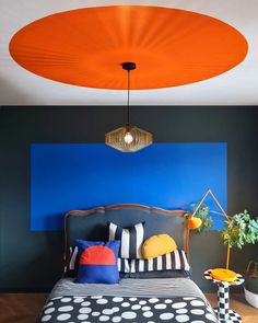 a bedroom with black, white and orange decor