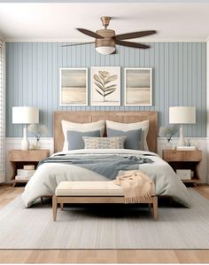 a bedroom with blue and white striped walls, a large bed in the center, two nightstands on either side