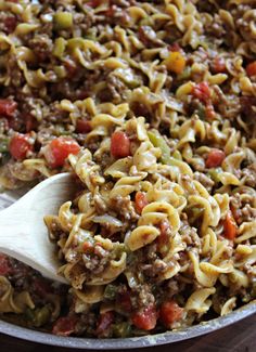 a skillet filled with pasta and vegetables