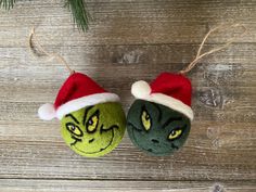 two green and red christmas balls with faces on them