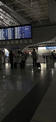 people are waiting for their luggage at the airport