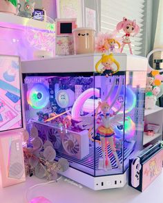 there is a small toy machine with many items on it's display stand and in front of other toys