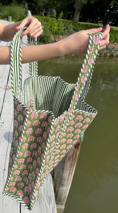 a person holding a bag on a wooden dock