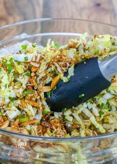 a glass bowl filled with coleslaw and chopped carrots