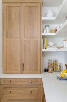 the kitchen is clean and ready for us to use it's natural wood cabinetry