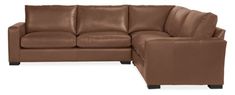 a brown leather sectional sofa sitting on top of a white floor