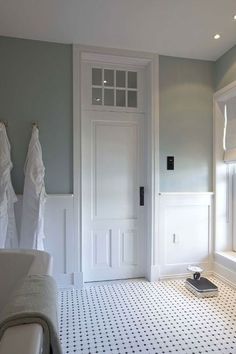 a bathroom with white towels hanging on the wall