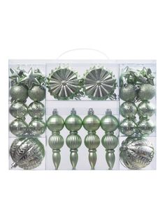 christmas ornaments are displayed in a clear box with green and silver decorations on the sides