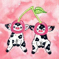 two black and white cows hanging upside down with cherries on their heads in front of a pink background